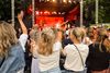 Blick auf die Bühne - eine Gruppe Frauen steht im Vordergrund und feiert und tanzt.